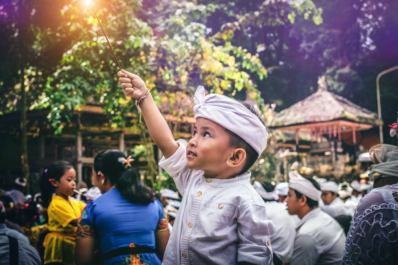 Boy holding a sparkler in Marga Indonesia